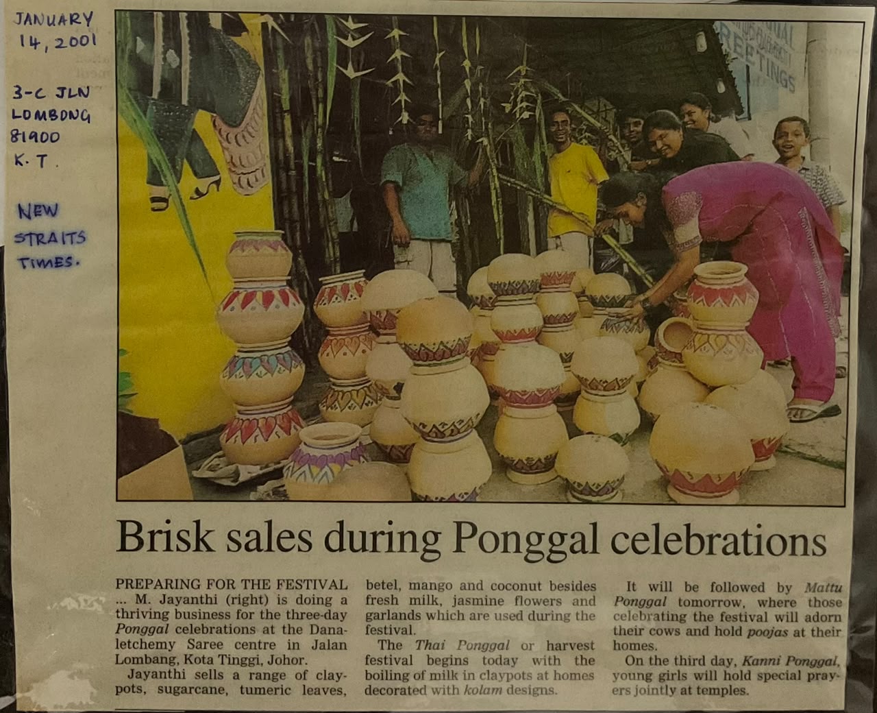Newspaper clipping headlined "Brisk sales during Ponggal celebrations": stacks of painted clay pots outside the saree centre in Kota Tinggi, with the family arranging them.